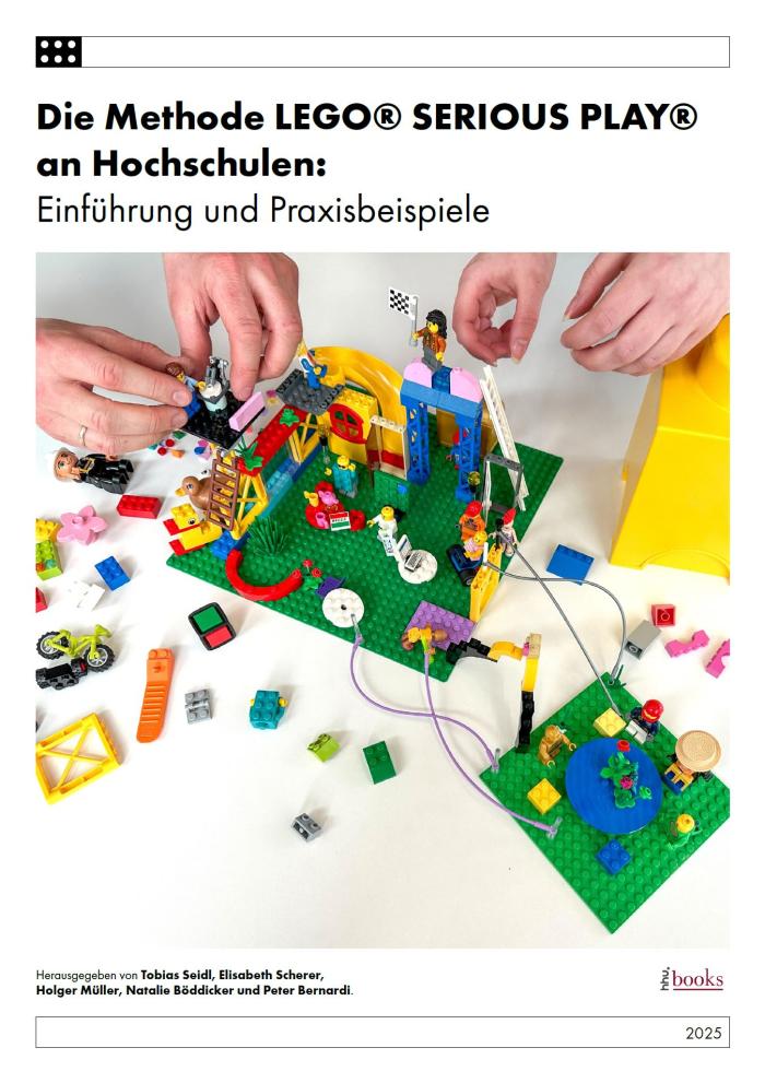 Lego being built by the hands of two people